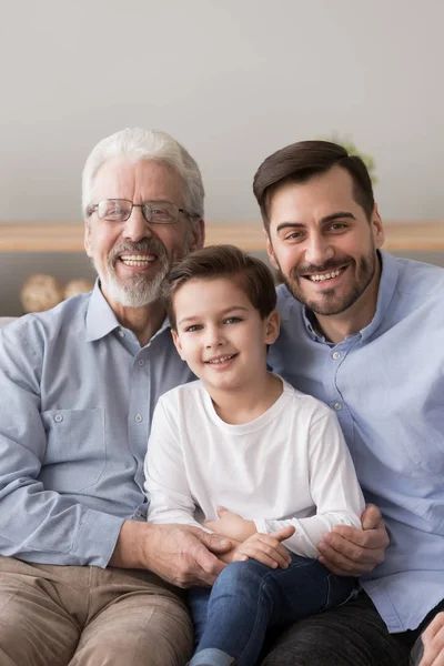 Portrait of three generations of men posing at home — Stock Photo, Image