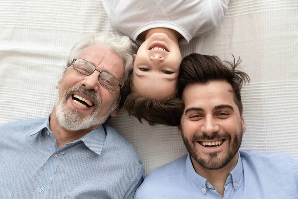 Top view of happy three generations of men smiling — Stock Photo, Image