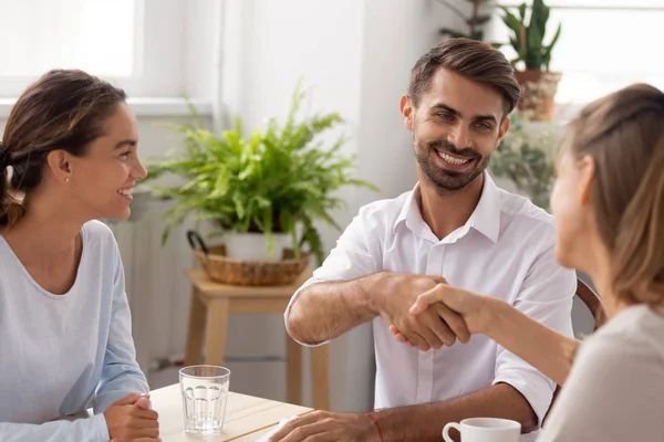 Smiling caucasian male manager, partner shaking hands thanking coworker — Stock Photo, Image