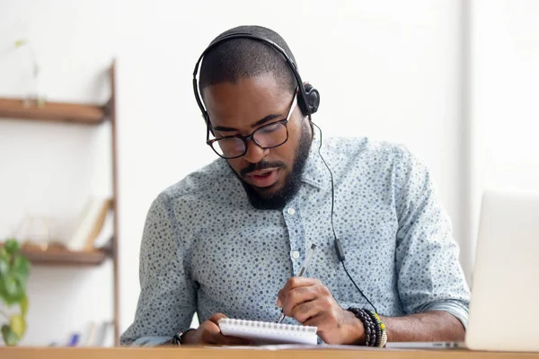 African American man in headphones taking E-learning course at office — Stock Photo, Image