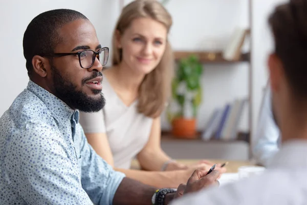 Male african-american talking to coworkers timeout in office — Stock Photo, Image