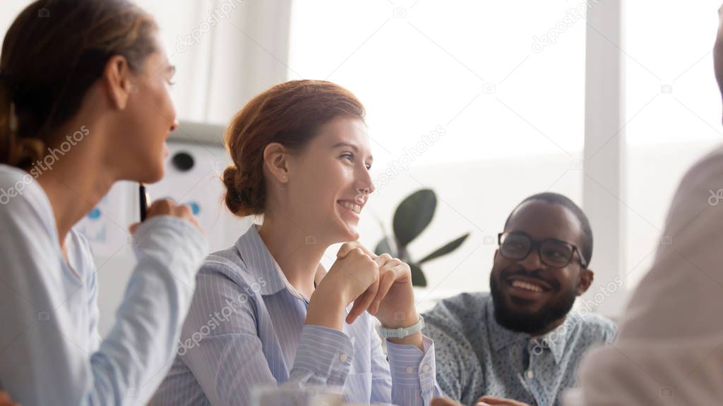 Happy joyful diverse business people talking laughing at funny joke