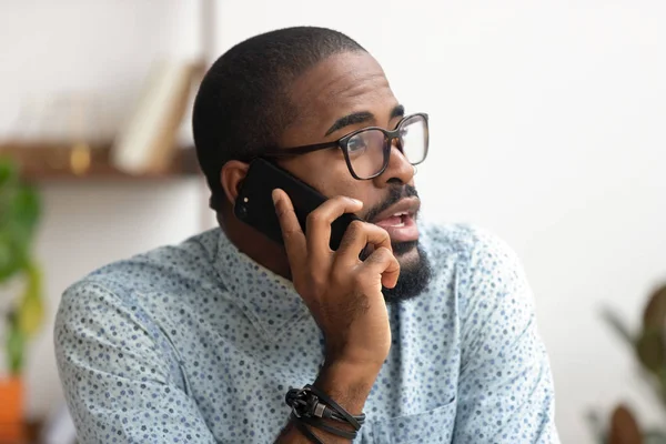 Chiudi dipendente afro-americano che parla telefono sul posto di lavoro in ufficio — Foto Stock