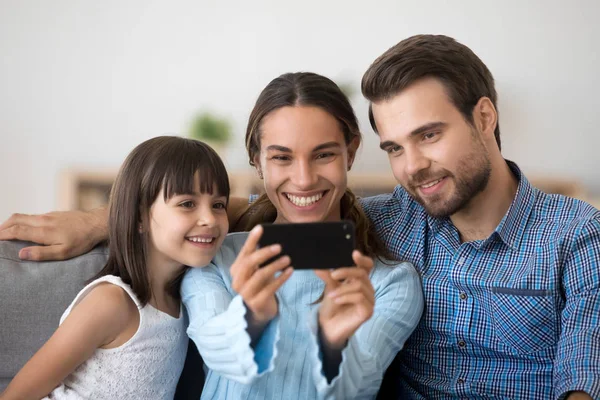 Famille heureuse avec sourire d'enfant faisant selfie sur la cellule — Photo