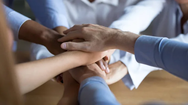 Close up diverse business people putting hands together, showing support — Stock Photo, Image