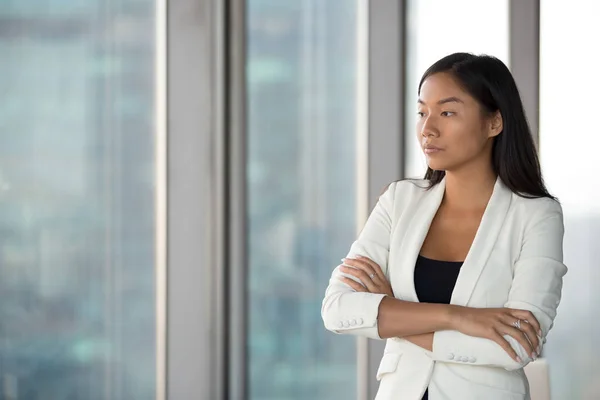 Pensive Asian female employee think of problem solution — Stock Photo, Image