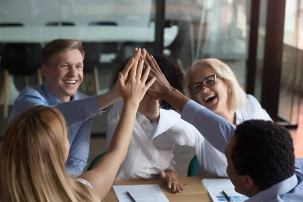 Diverse team of employees giving high five at briefing — Stock Photo, Image