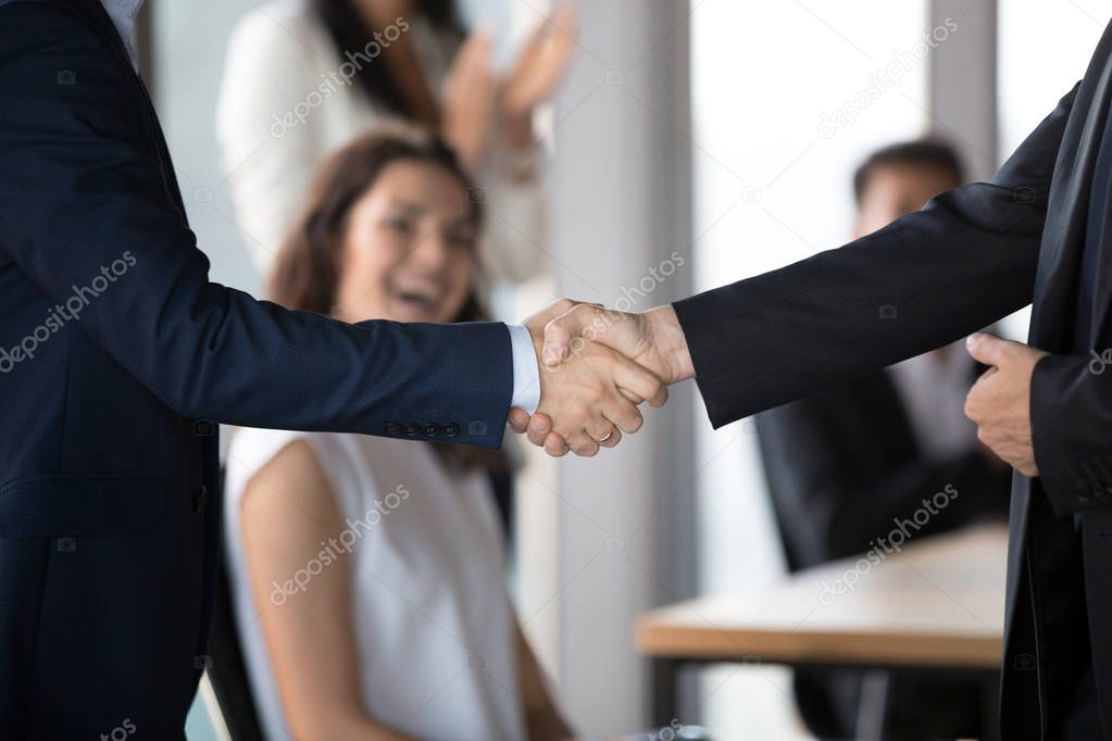 Close up of businessmen handshake closing successful business deal