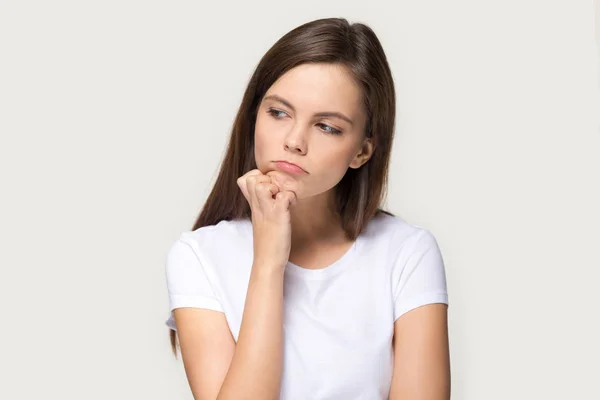 Millennial sad pensive woman feels upset isolated on grey background — Stock Photo, Image