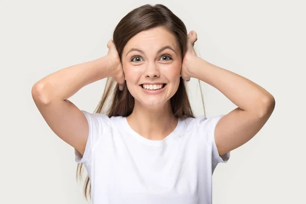 Irritated woman shut her ears with hands studio shot — Stock Photo, Image