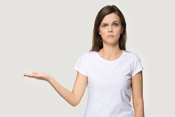 Dissatisfied woman showing empty open palm copy space studio shot — Stock Photo, Image