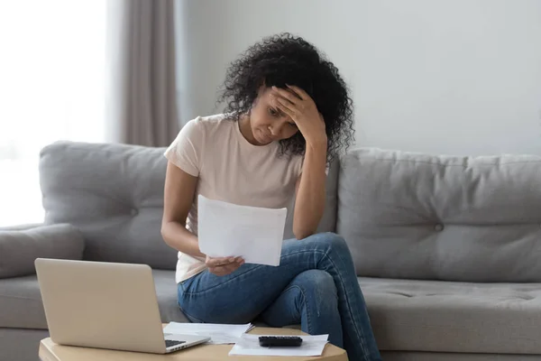Stressed african woman holding bills worried about bankruptcy bank debt — Stock Photo, Image