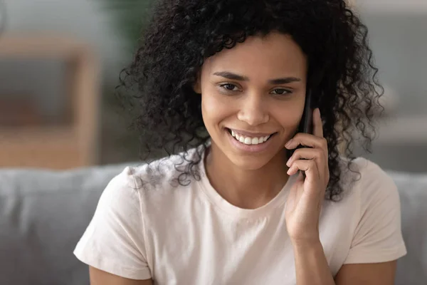 Heureuse femme afro-américaine parlant sur un téléphone portable à la maison — Photo