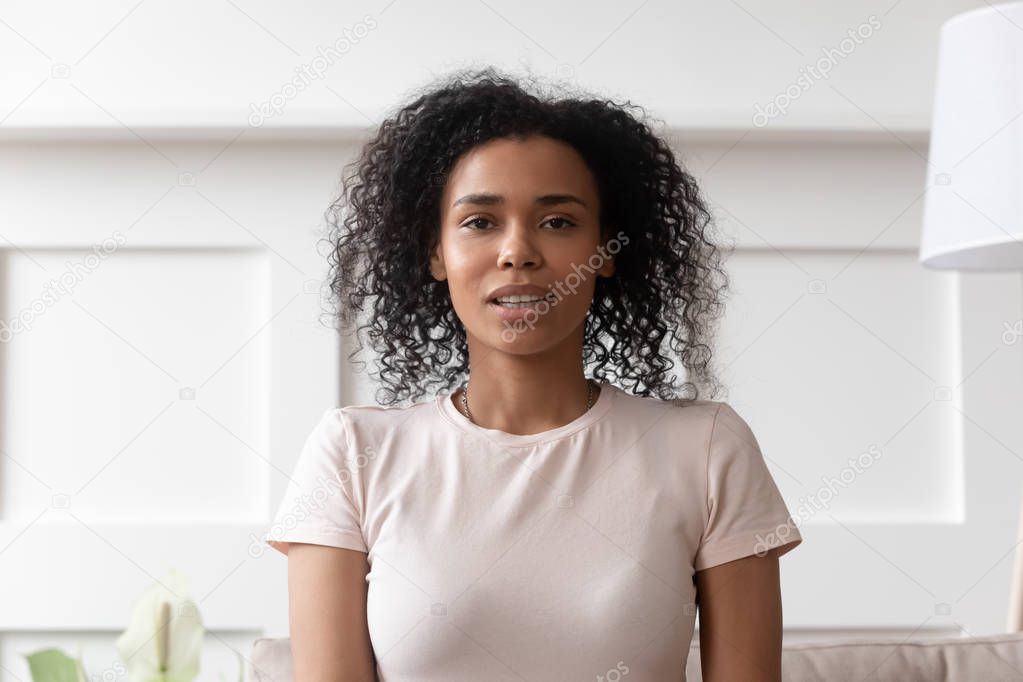 Young african woman video calling looking at camera at home