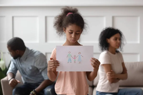 Sad african girl holding family picture upset about parents divorce — Stock Photo, Image