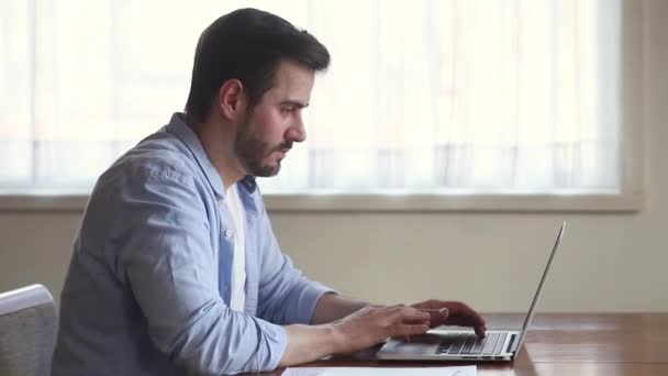 Overjoyed excited young man looking at laptop celebrating success victory — Stock Video