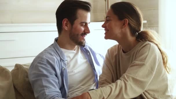 Loving young couple bonding laughing touching foreheads relaxing at home — Stock Video