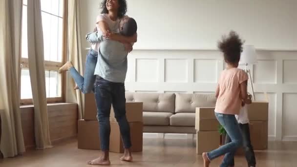 Happy overjoyed african family celebrate moving day relocation together — Stock Video
