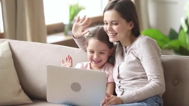 Счастливая мать с ребенком дочь делает видеозвонок на ноутбуке — стоковое видео