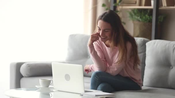 Mujer joven feliz agitando las manos haciendo videollamada en el ordenador portátil — Vídeos de Stock