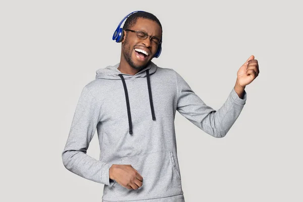 Homem negro excitado em fones de ouvido se divertir apreciando música — Fotografia de Stock
