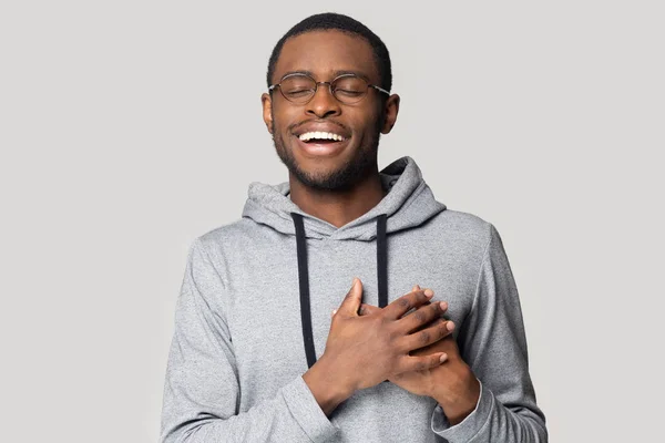 Grateful black male believer touch heart feel thankful — Stock Photo, Image