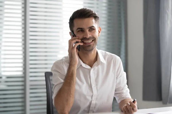 Smiling businessman talking on phone making business call in office — Stock Photo, Image