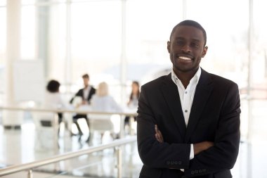 Portre gülümseyen Afrikalı Amerikan işadamı koridorda kamera bakmak