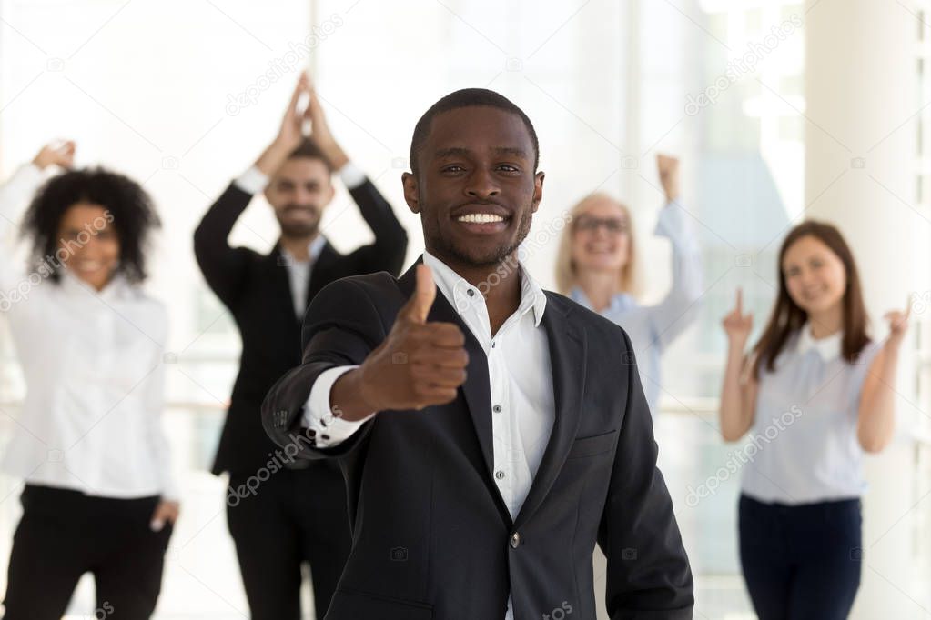 Excited African American leader, employee or manager show thumbs up