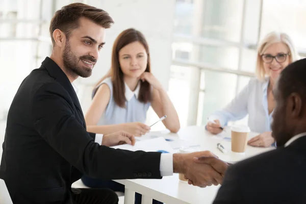 Confident businessman shaking hand colleague at company meeting — Stock Photo, Image