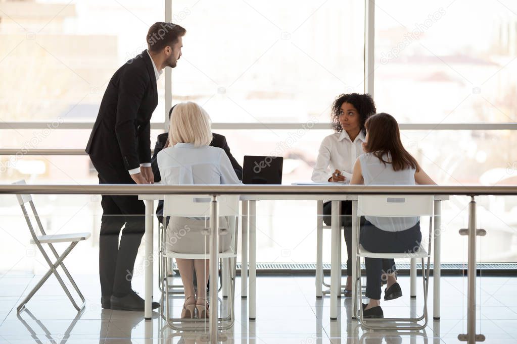 Employees discuss new project with boss holding business briefing