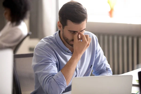 Empresário cansado tirando óculos depois de longas horas de trabalho no computador — Fotografia de Stock