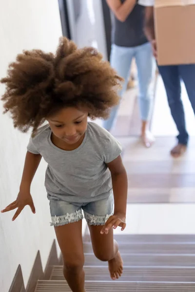 African kid runs to second floor of new modern house — Stock Photo, Image