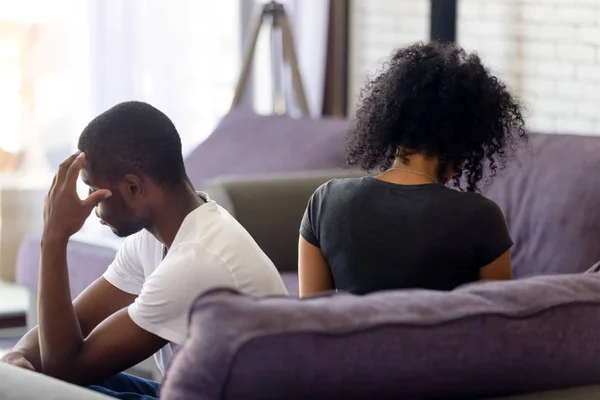 Rear view black couple sitting separately on couch not talking — Stock Photo, Image