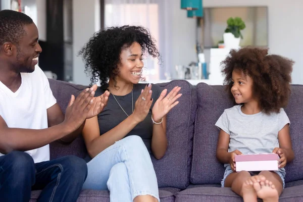 Loving african parents clap hands congratulating little daughter happy birthday — Stock Photo, Image