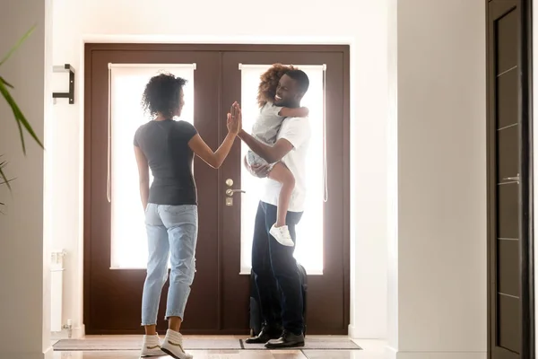 Happy african wife and little daughter meet at doorway father — Stock Photo, Image