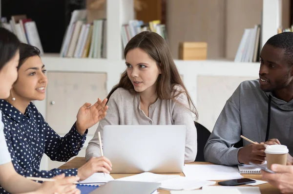 Diverse young people at shared desk studying together — Stock Photo, Image