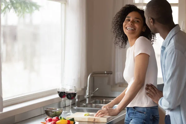 African wife prepare dinner for romantic date talk with husband