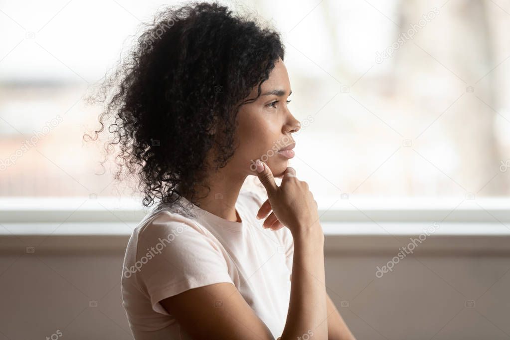 Pensive mixed race woman thinking makes decision, side view
