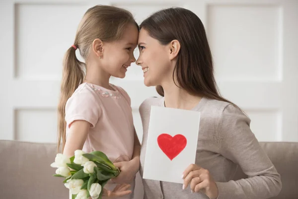 Mother and daughter gently touches foreheads celebrates international womens day — Stock Photo, Image