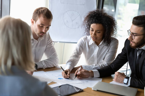 Diverse employees discussing business strategy, working on project together