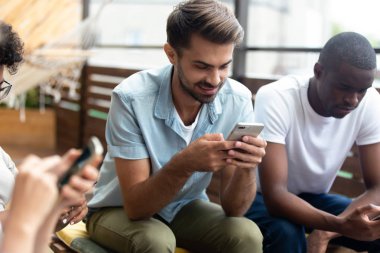 Akıllı telefonları kullanan farklı gençler birlikte takılır