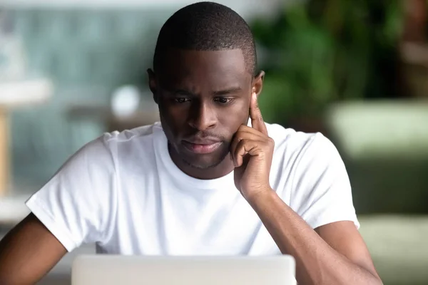 Pensive black male think working at laptop — Stock Photo, Image