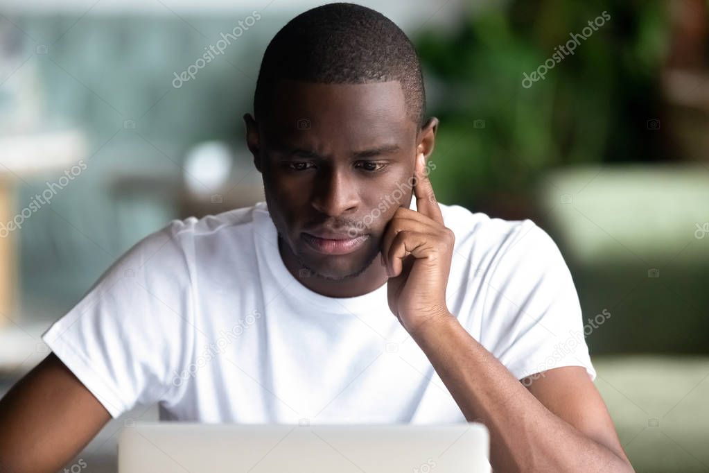 Pensive black male think working at laptop
