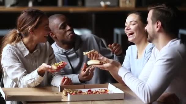 Multi amigos étnicos pasar tiempo juntos charlando riendo comiendo pizza — Vídeo de stock