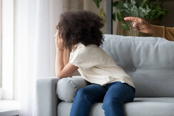 Stubborn offended African American girl daughter ignoring angry father