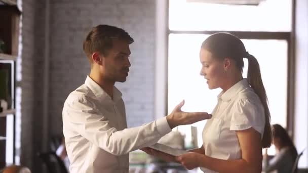 Colleagues having misunderstanding different opinion arguing standing in coworking space — Stock Video