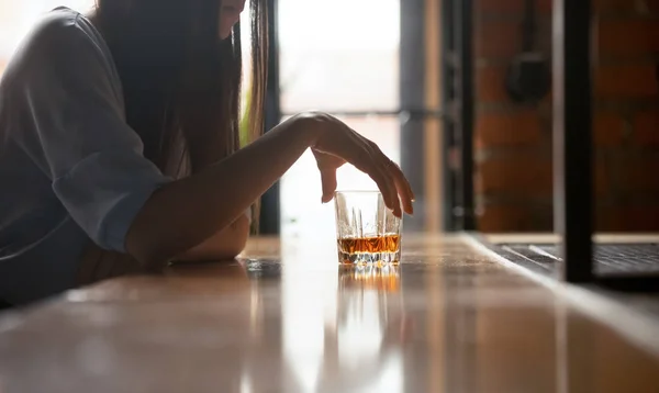 Sad woman drinker holding whiskey glass drinking alone in bar — Stock Photo, Image