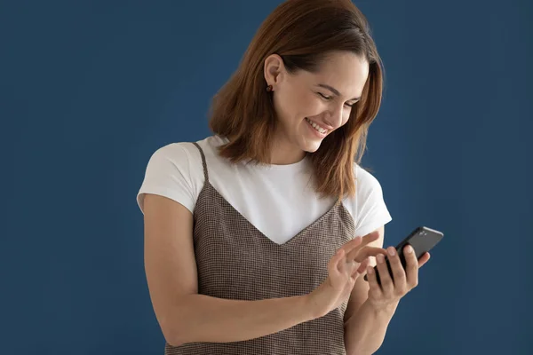 Happy woman using phone, reading funny news, laughing isolated — Stock Photo, Image