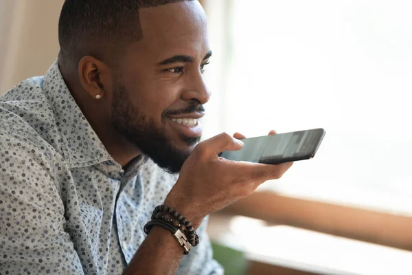 Close up happy black man dictating voice message. — Stock Photo, Image